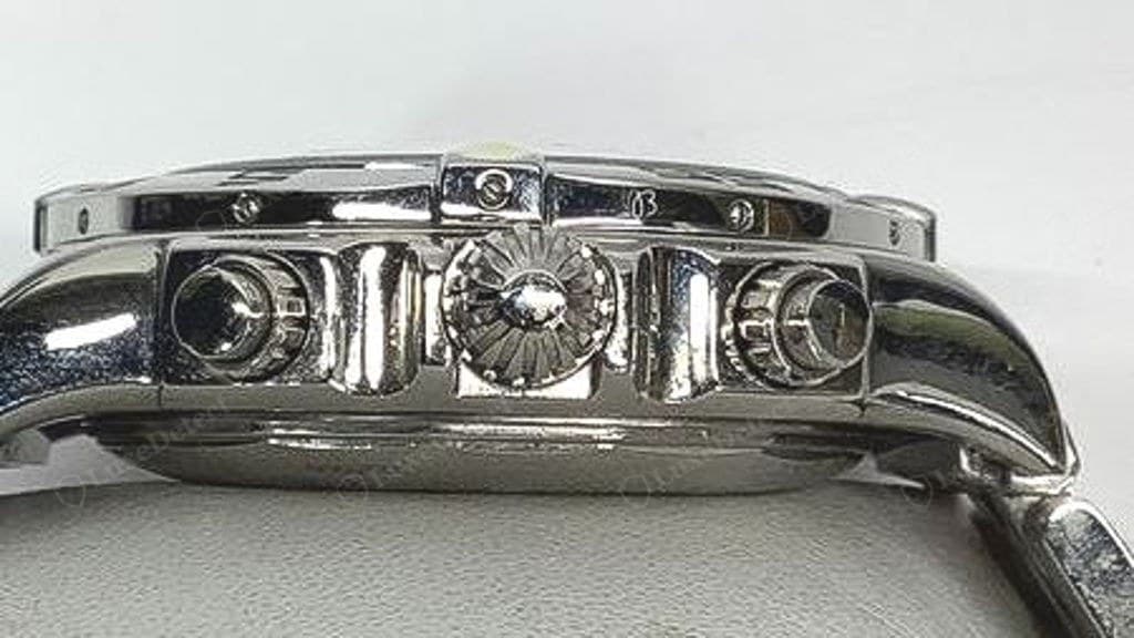 Side profile of a watch from a counterfeit order — crown and both pushers are visible; reset accuracy and pusher feel are checks done with the watch in hand
