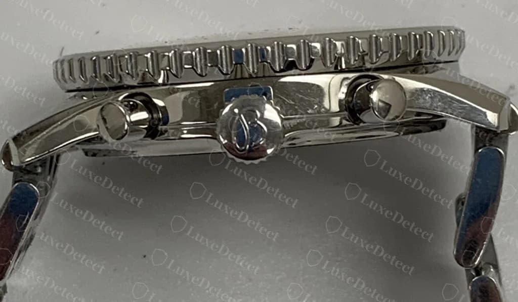 Genuine Breitling chronograph in side profile — Breitling's B-logo crown flanked by the two pushers, with a notched rotating bezel above