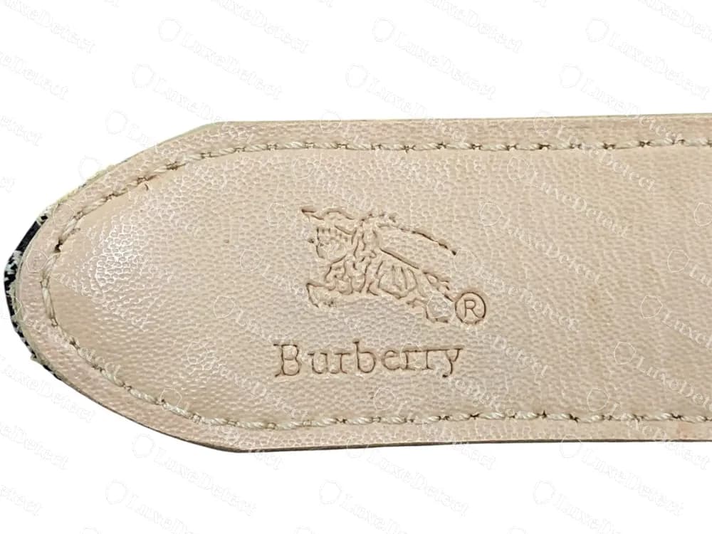 Fake-ruled belt: lining tip stamped with a small knight, an ® and script Burberry in lowercase