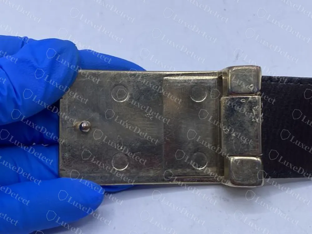 Authentic plaque buckle seen from the back, flat plate with a neat hinge and fixings