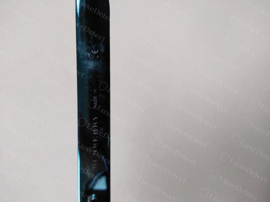 Counterfeit temple engraving: the wordmark wavers off a straight baseline and the letters are unevenly spaced.