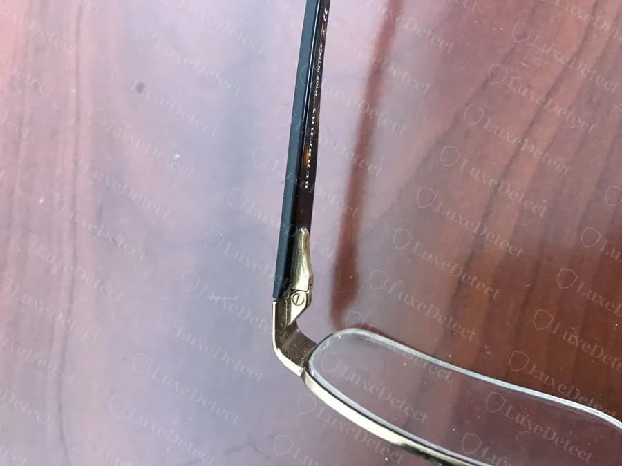 Authentic Burberry temple engraving: even baseline, consistent letter spacing and depth, no stray marks.