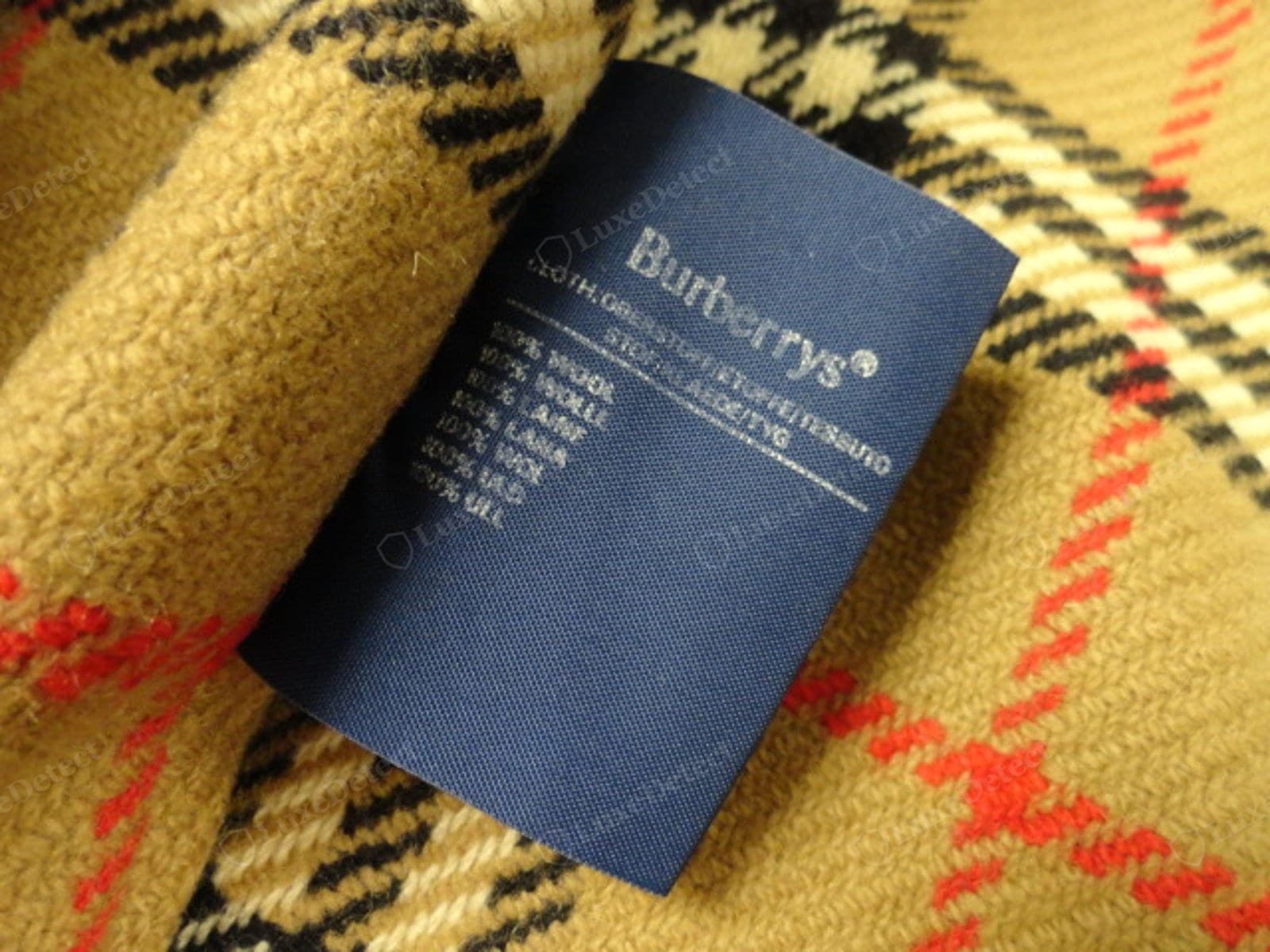Counterfeit Burberry care label — spelling errors, impossible care symbols, a missing or invalid RN number