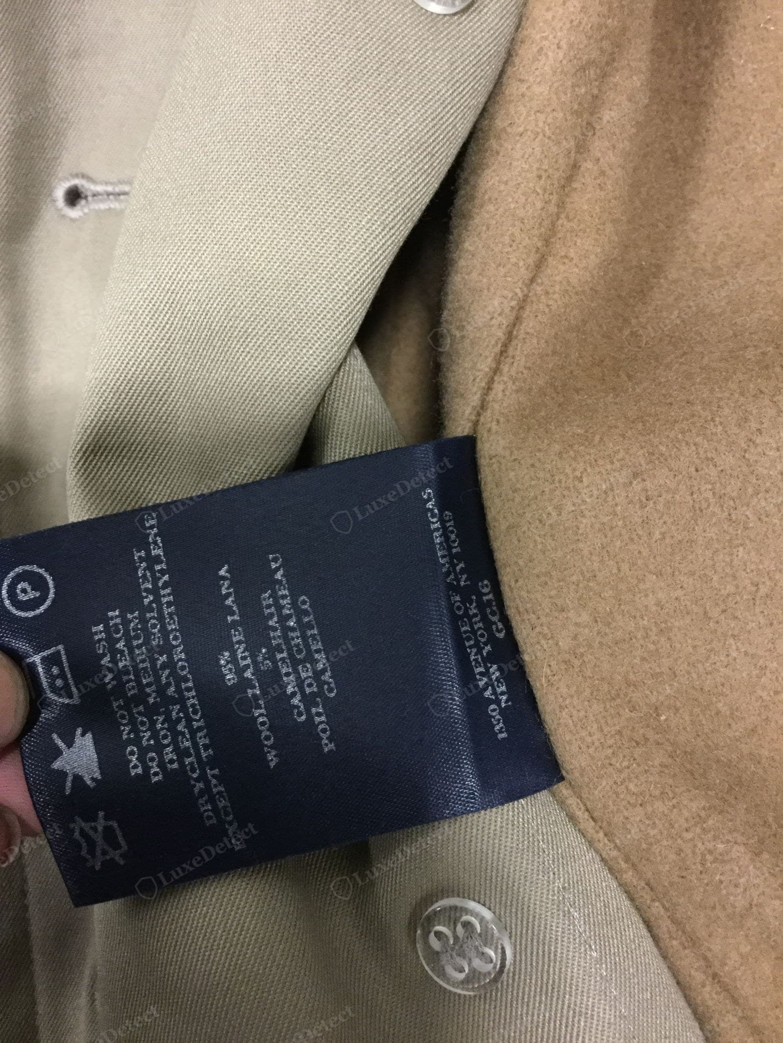 Genuine Burberry gabardine — the fine, dense diagonal twill wale visible on the lapel of a wool-blend trench, matte and tightly woven, beside a camelhair undercollar