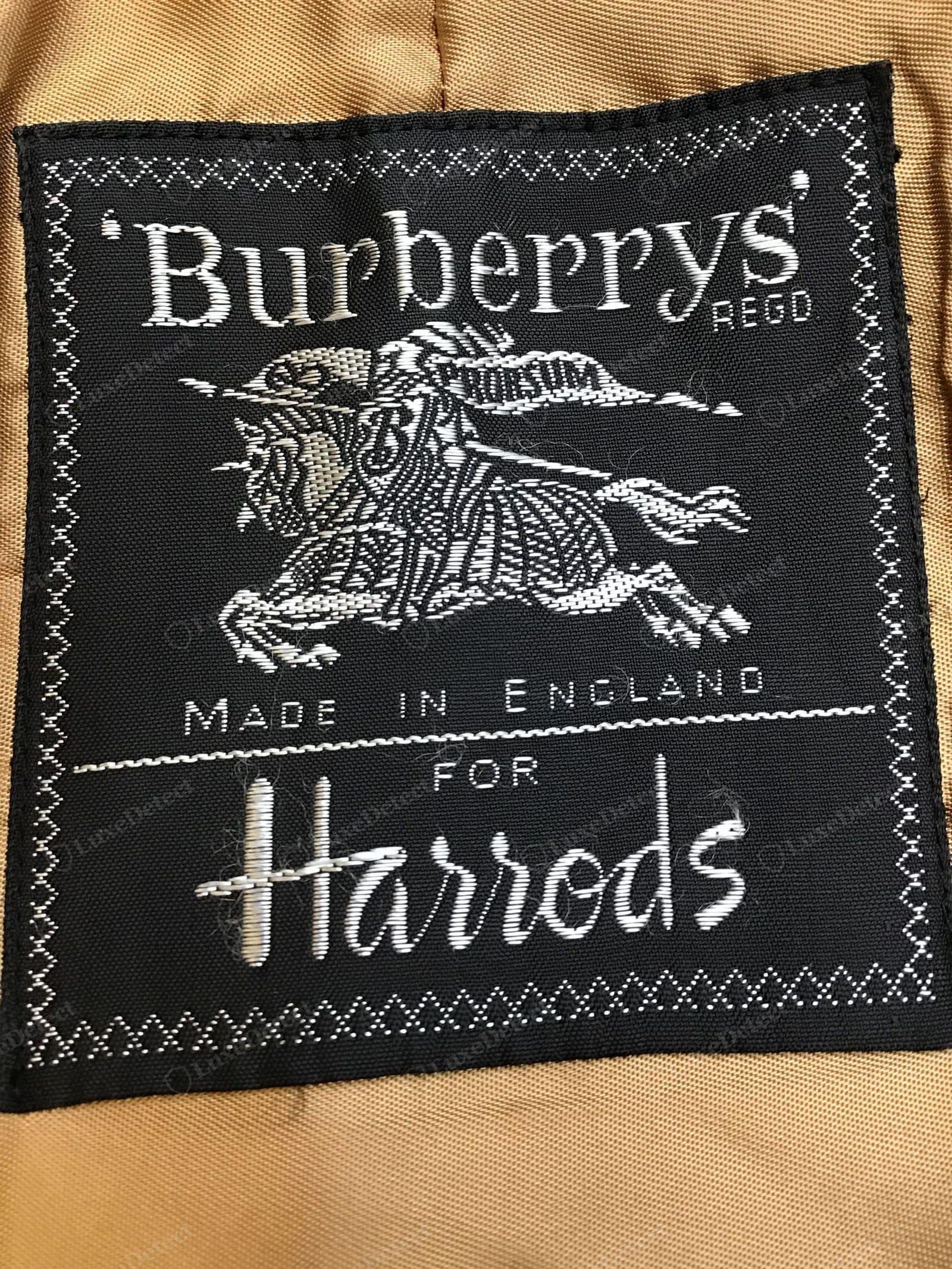 Counterfeit vintage Burberry label — a modern logo or wrong "Burberrys" styling on a coat sold as older vintage, or a printed/crude weave