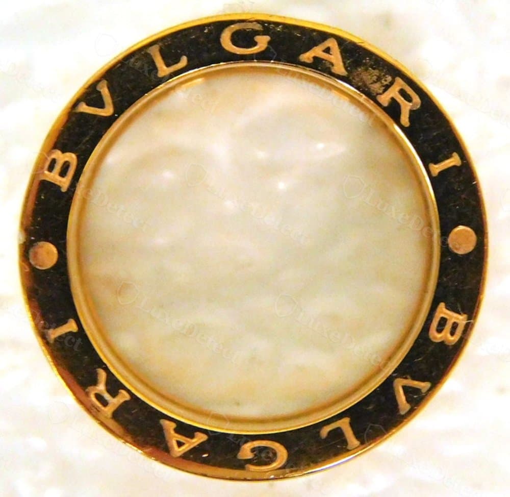 A counterfeit interior with no visible fineness stamp, assay mark, or brand mark at all — a bare band where genuine hallmarks belong.