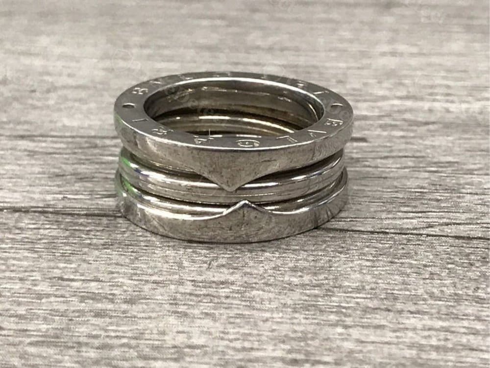 A counterfeit ring with a rougher matte finish and a visible seam where the bands meet, instead of a clean polished transition.