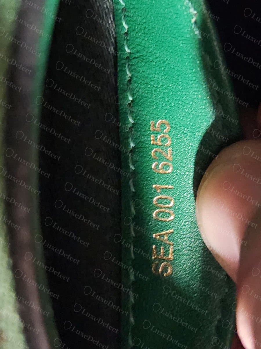 Fake Bvlgari bag serial embossed into an interior pocket lining, reading SEA 001 6255 rather than a three-part serial