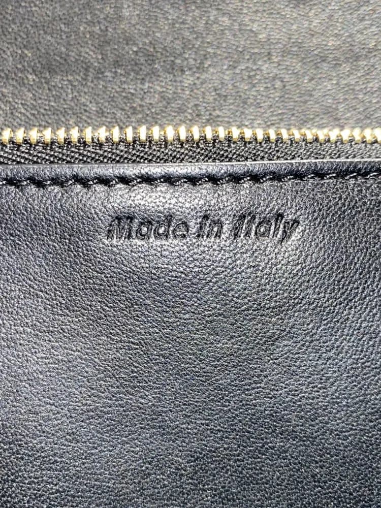 Counterfeit "Made in Italy" stamp on black lining. The letters are thick, heavy and pressed deep, and read far more boldly than on the genuine bags we compared.