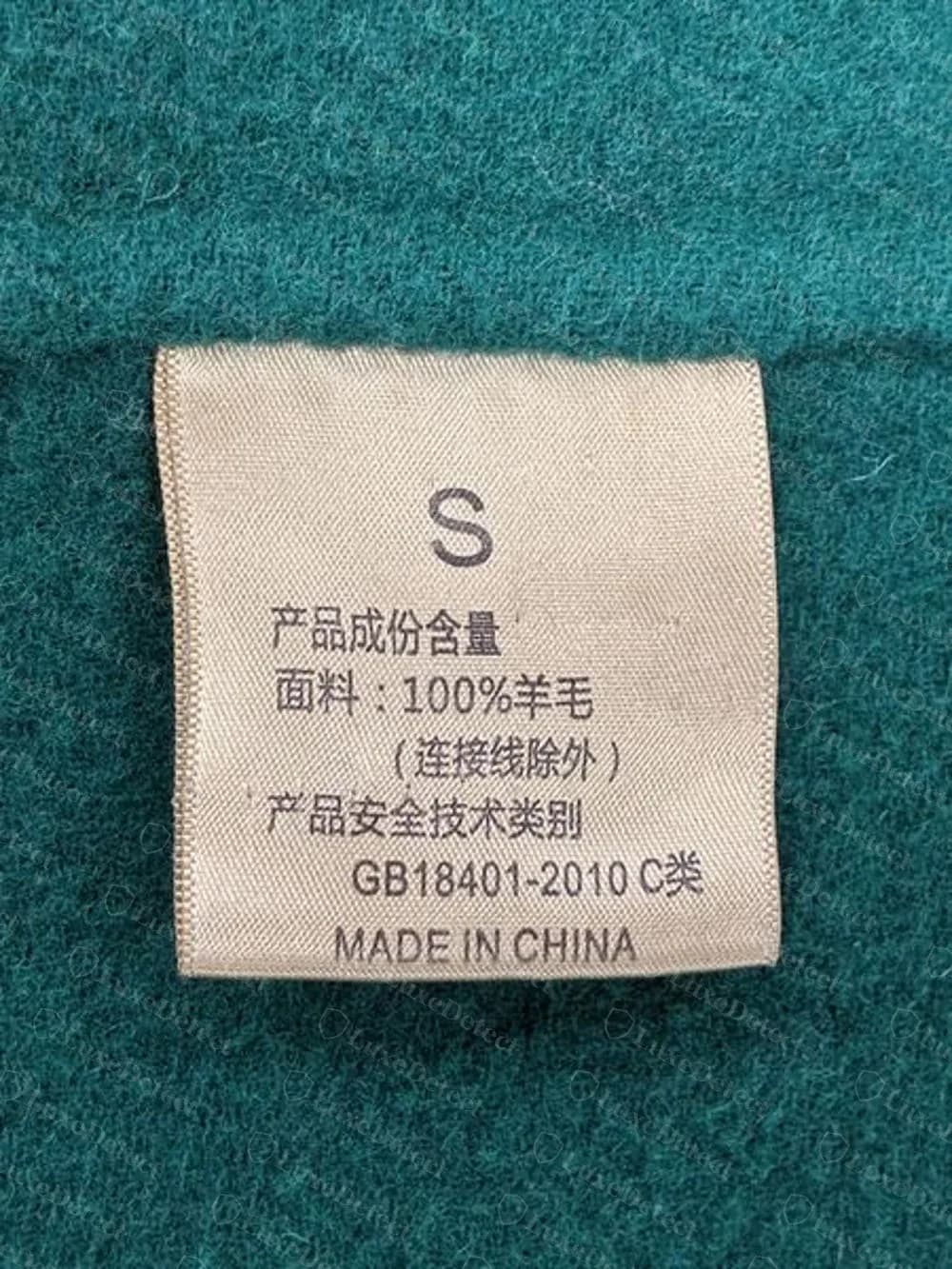 Counterfeit Celine coat: a size tag with Chinese composition text, GB18401-2010 and Made in China, no Celine name