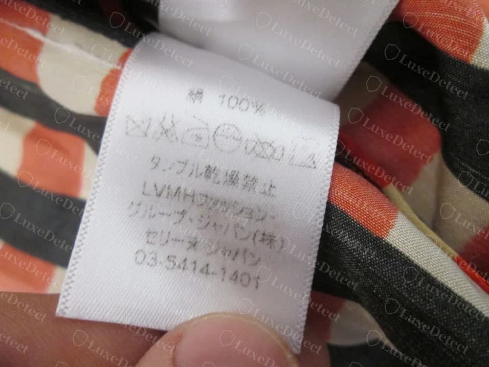 Counterfeit Celine blouse: a Japanese label reading cotton 100% and LVMH Fashion Group Japan