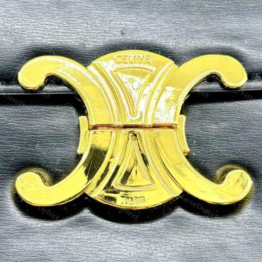Counterfeit Triomphe clasp from a second archive order: CELINE and PARIS are soft and rounded, as if moulded rather than engraved, under a bright, brassy plating.