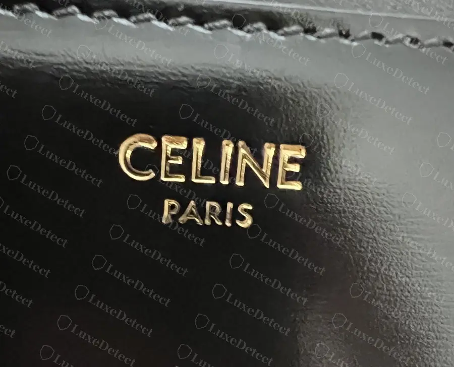 Authentic heat stamp on a black shiny-calfskin Teen Triomphe: solid foil, clean edges, compact letter spacing.