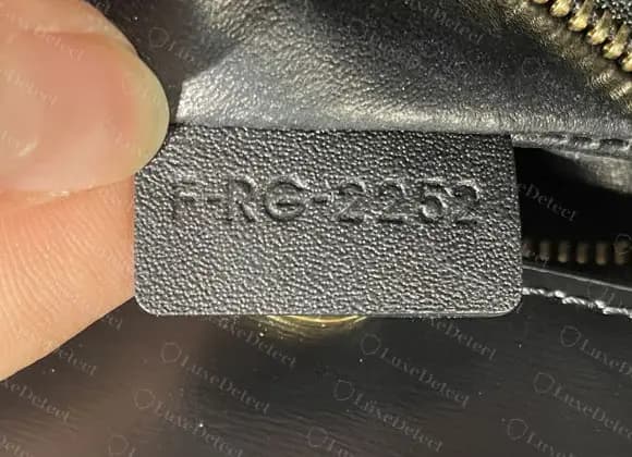 Authentic Teen Triomphe serial tag: F-RG-2252, capital letters and four digits, pressed evenly into a tab cut from the lining leather.