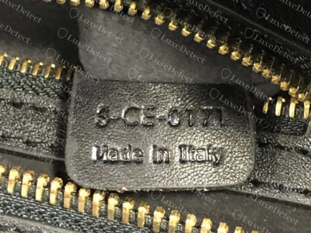 A counterfeit Celine Mini Luggage with a code stamped on a black leather tab above Made in Italy: S-CE-0171