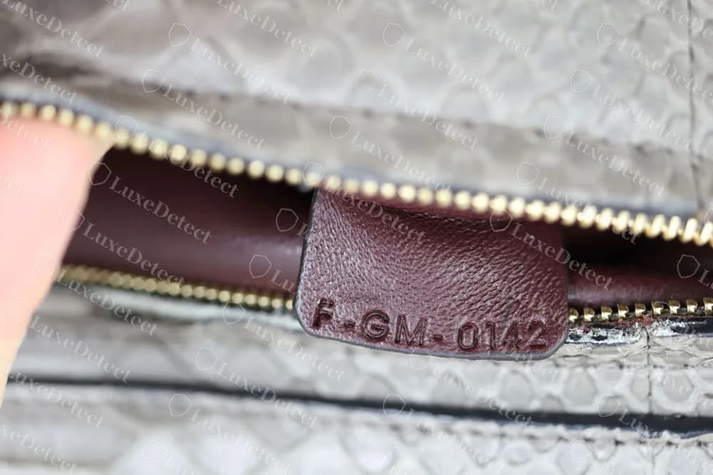 A genuine Celine Trapeze in python with a code stamped on a burgundy leather tab at the interior zip: F-GM-0142