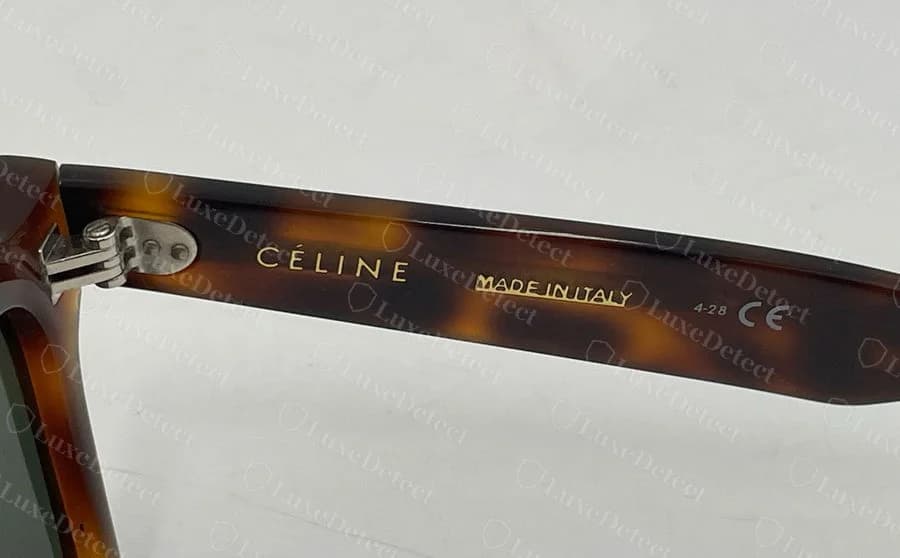 Counterfeit Celine temple: CÉLINE, MADE IN ITALY and a date code reading 4-28, a production year that has not happened yet.