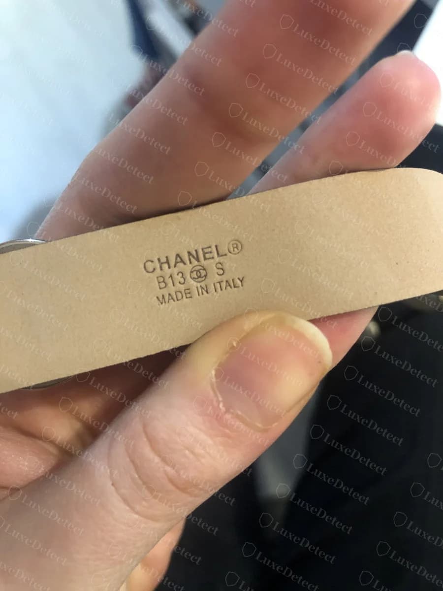 Genuine Chanel leather back-stamp reading "CHANEL®," a size code, a small CC glyph, and "MADE IN ITALY," stamped cleanly into the interior strap leather