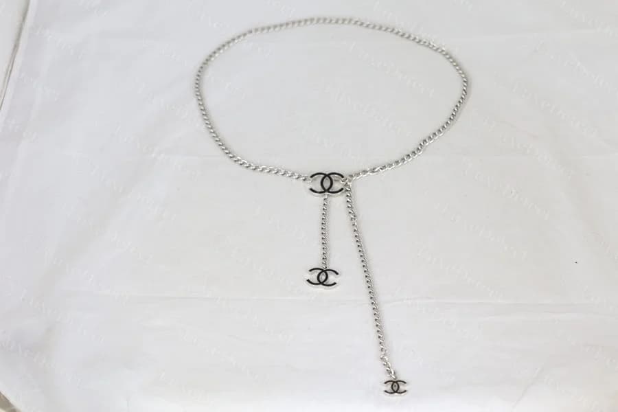 Genuine Chanel chain belt with two CC medallion drop charms hanging from the central link, cast (not printed) directly into the metal