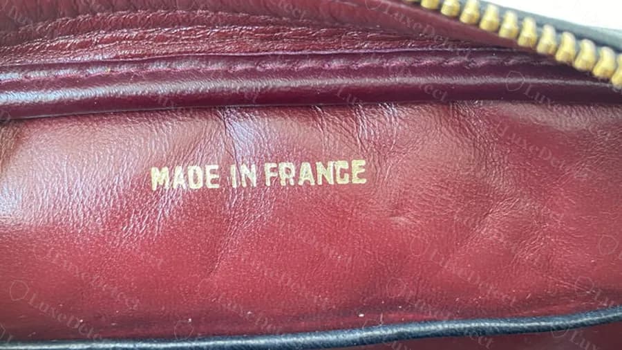 Genuine gold MADE IN FRANCE stamp on the burgundy leather lining of a vintage Chanel Camera Bag