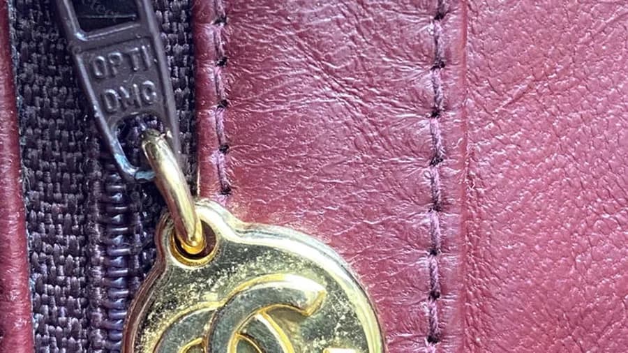 Genuine oval gold CC zip charm on a vintage Camera Bag, with a zip pull stamped with the maker's name