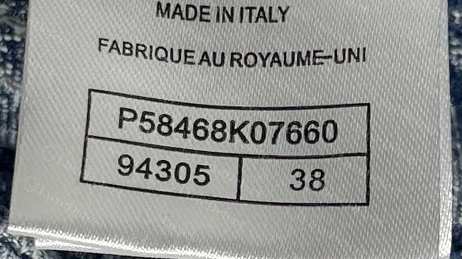 Fake Chanel style label where the English says Made in Italy and the French says Fabrique au Royaume-Uni, above a boxed code and size 38