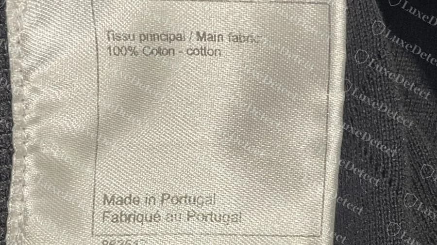 Genuine Chanel composition label on a cotton knit reading Made in Portugal, Fabrique au Portugal, with fabric content in French and English