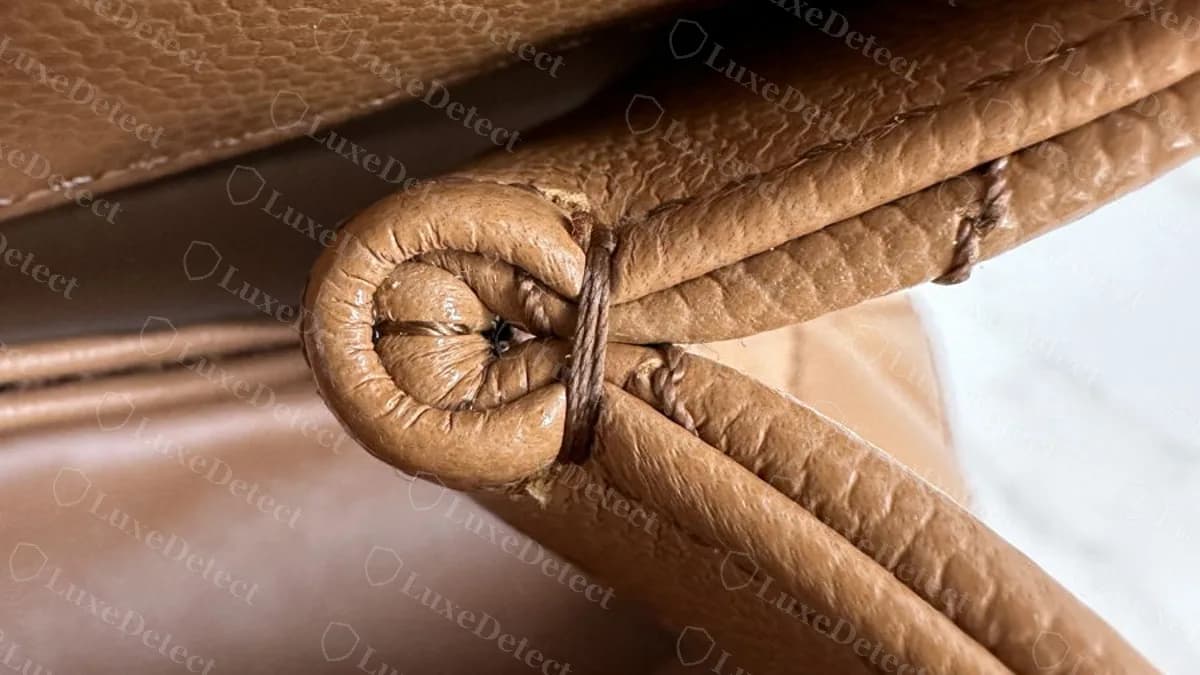Inside corner of the flap on a genuine Coco Handle: leather folded into a neat rolled corner, finished with tight stitches