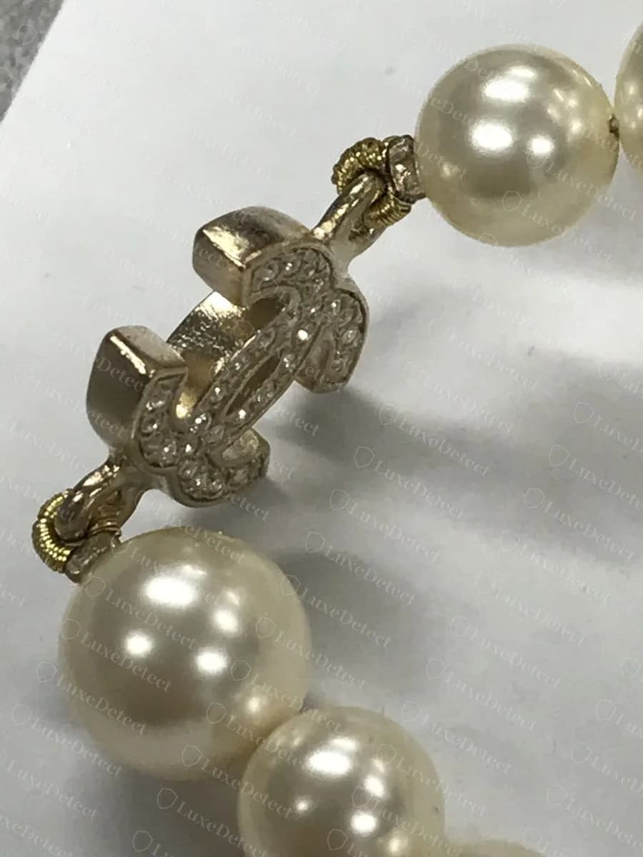 Genuine Chanel pearl necklace, a crystal CC station joined to the strand of glass pearls with coiled gold gimp at each end