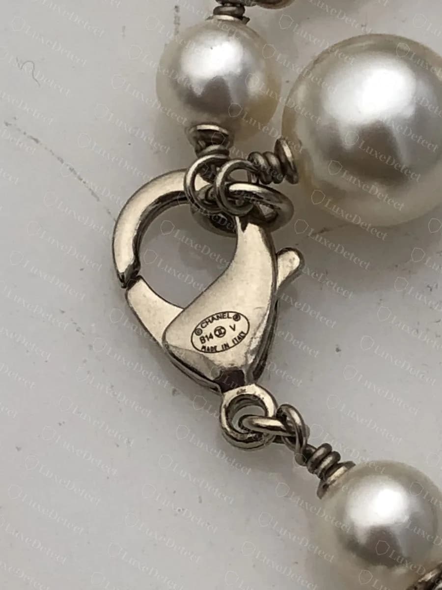 Genuine Chanel pearl sautoir, each pearl individually wire-wrapped on a rosary link, with the lobster clasp stamped "©CHANEL® B14 V MADE IN ITALY"