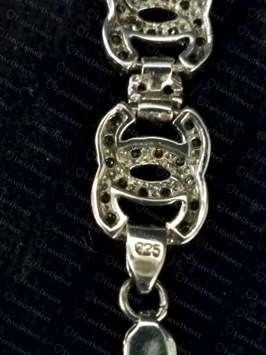 Counterfeit Chanel CC bracelet, rhinestone links with a "925" silver mark on the clasp tab and no Chanel plaque anywhere on the piece