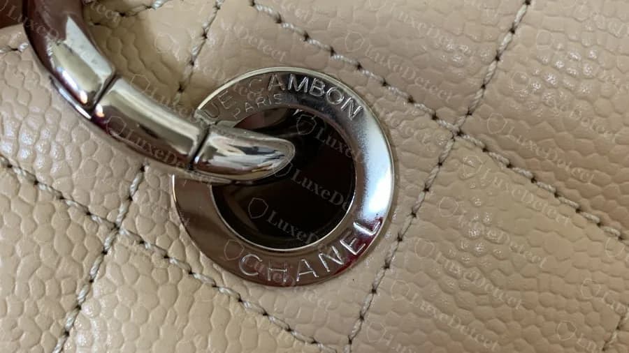 Genuine beige GST grommet in silver: a ring engraved 31 RUE CAMBON PARIS along the top and CHANEL along the bottom, set flush in the quilting