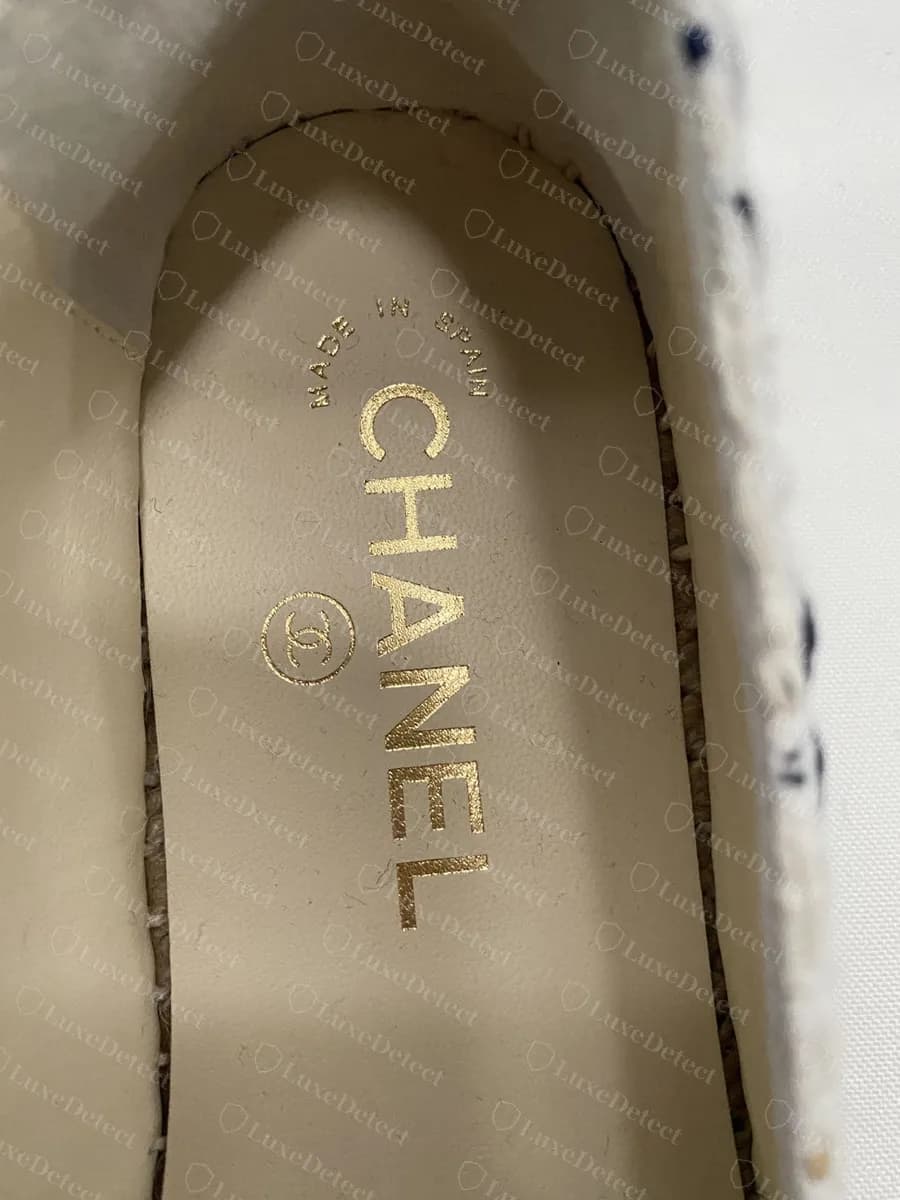 Counterfeit Chanel espadrille insole with a correct MADE IN SPAIN arc, CHANEL and the CC roundel in gold foil