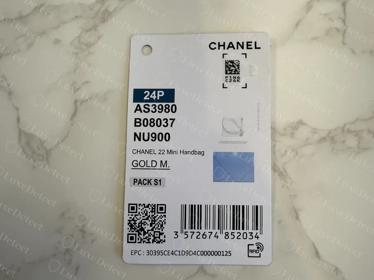 Retail hangtag from a Chanel 22 Mini: the CHANEL name, the season, a style code AS3980, the line "CHANEL 22 Mini Handbag" and a barcode