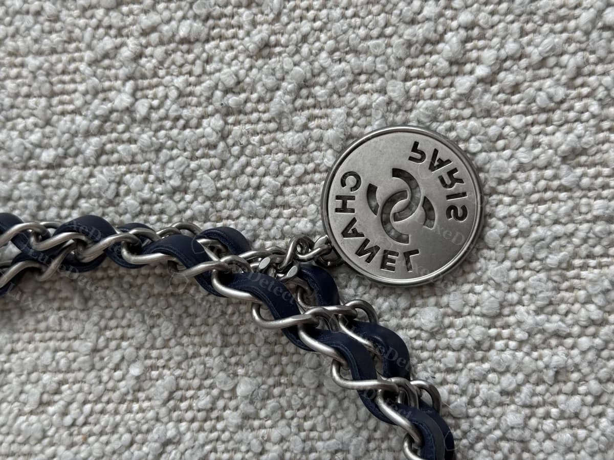 Genuine round medallion on a denim Chanel 22 chain: CHANEL and PARIS around the interlocking CC