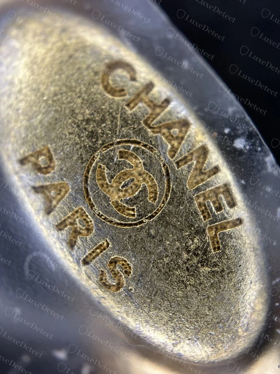 Genuine hardware plate stamped "CHANEL" and "PARIS" with the CC logo centered between them, cleanly engraved
