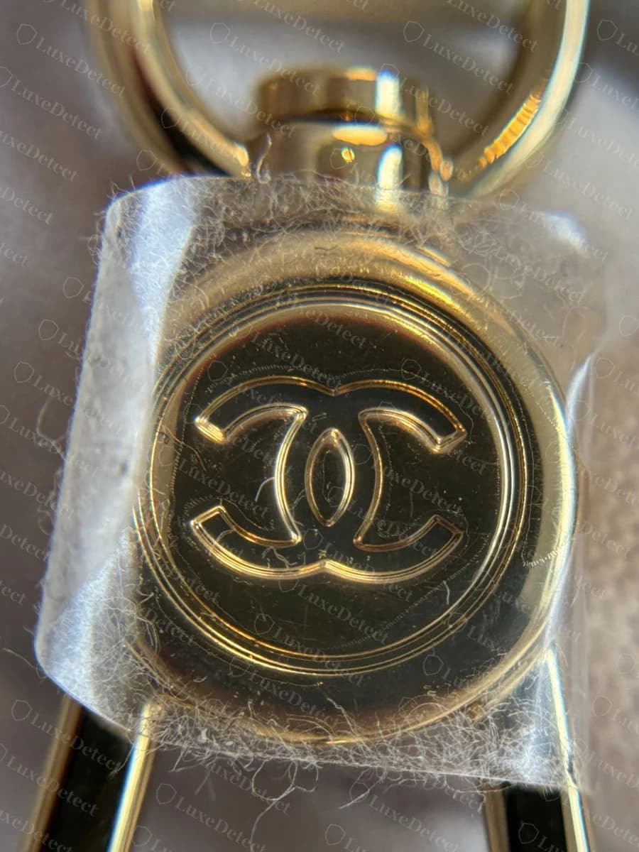 Genuine Chanel Deauville — the CC turn-lock and zip-pull hardware cleanly cast, no third-party manufacturer branding anywhere on the metal