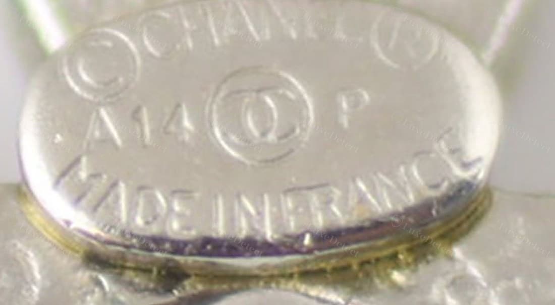 Genuine Chanel earring hallmark — "©CHANEL®", the CC logo between a year code and season letter, "MADE IN FRANCE" beneath, every character struck cleanly to an even depth