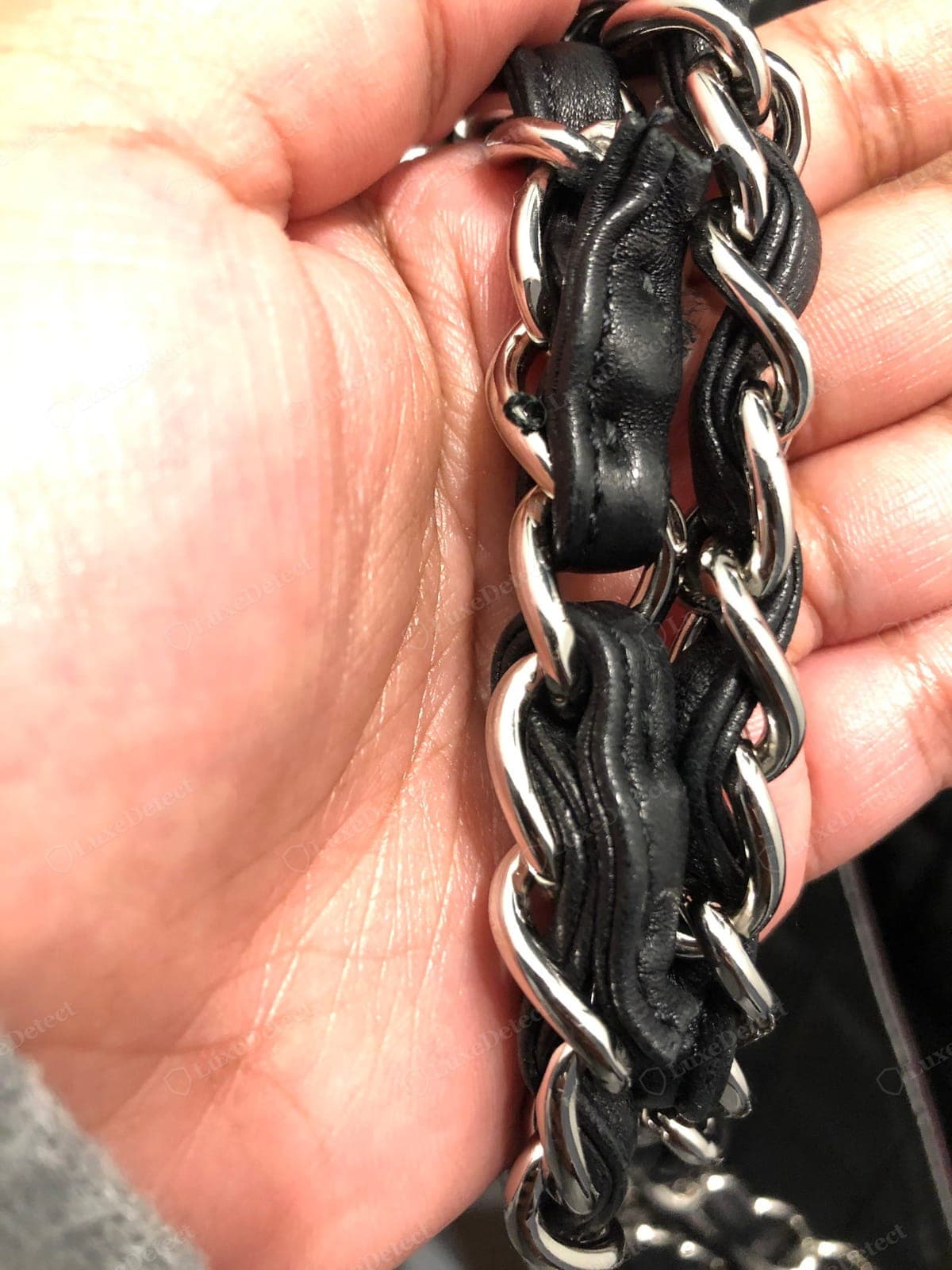 Counterfeit Chanel chain — lightweight links, leather threaded unevenly or bunching, thin or brassy plating