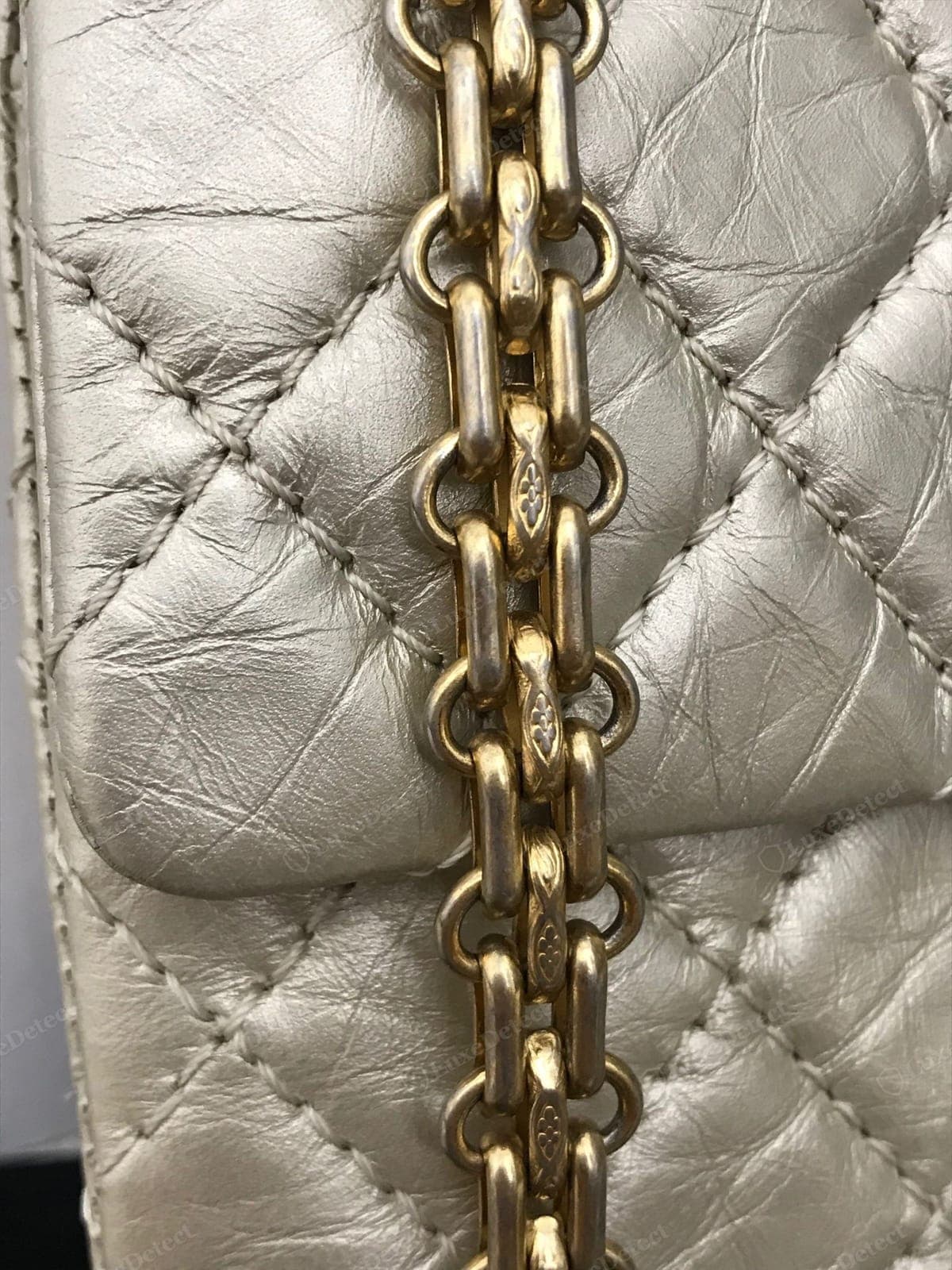 Genuine Chanel chain — heavy interlocking links with the leather threaded evenly through, a warm consistent plating