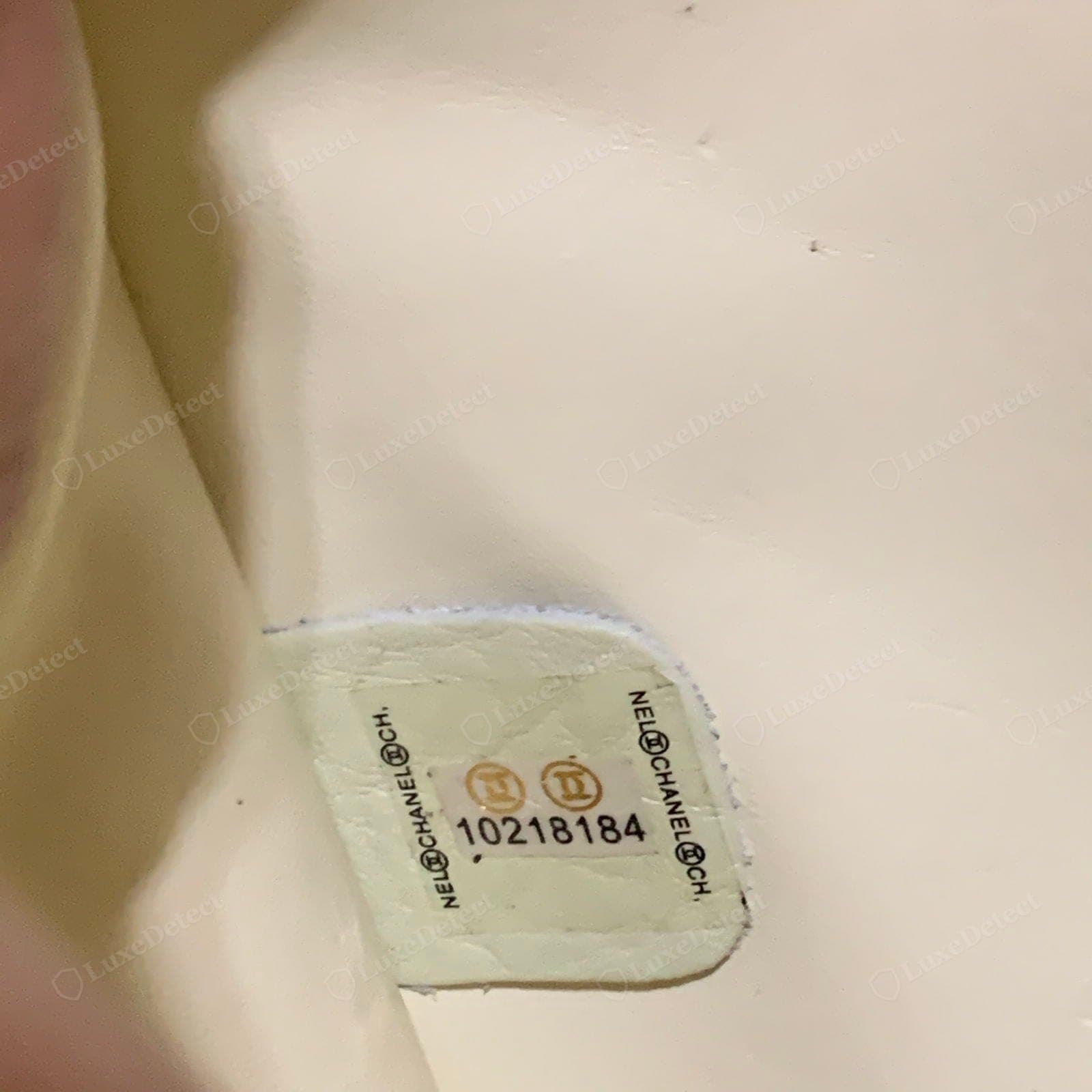 Counterfeit Chanel hologram sticker — a flat or crudely printed foil, text that does not shift, wrong colour play, lifting edges