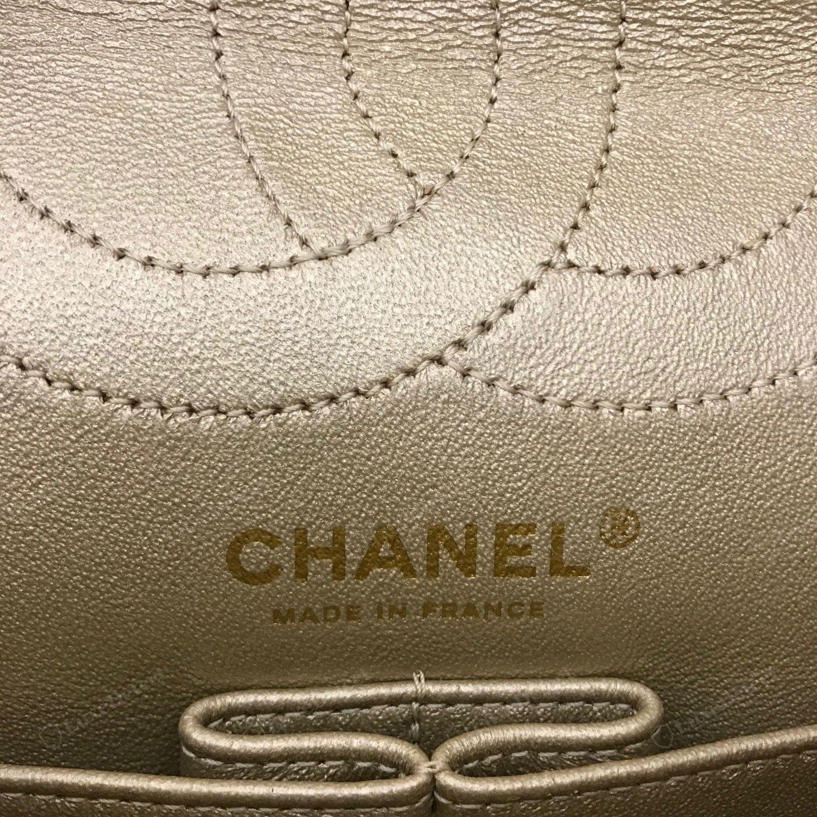Genuine Chanel Classic Flap interior — well-finished leather lining, the stamped CC / "CHANEL" above the "MADE IN" line, clean stitching