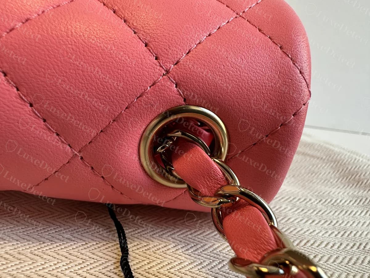 Genuine Mini Flap chain grommet: a metal ring set in the top corner of the bag with a leather-laced chain running through it