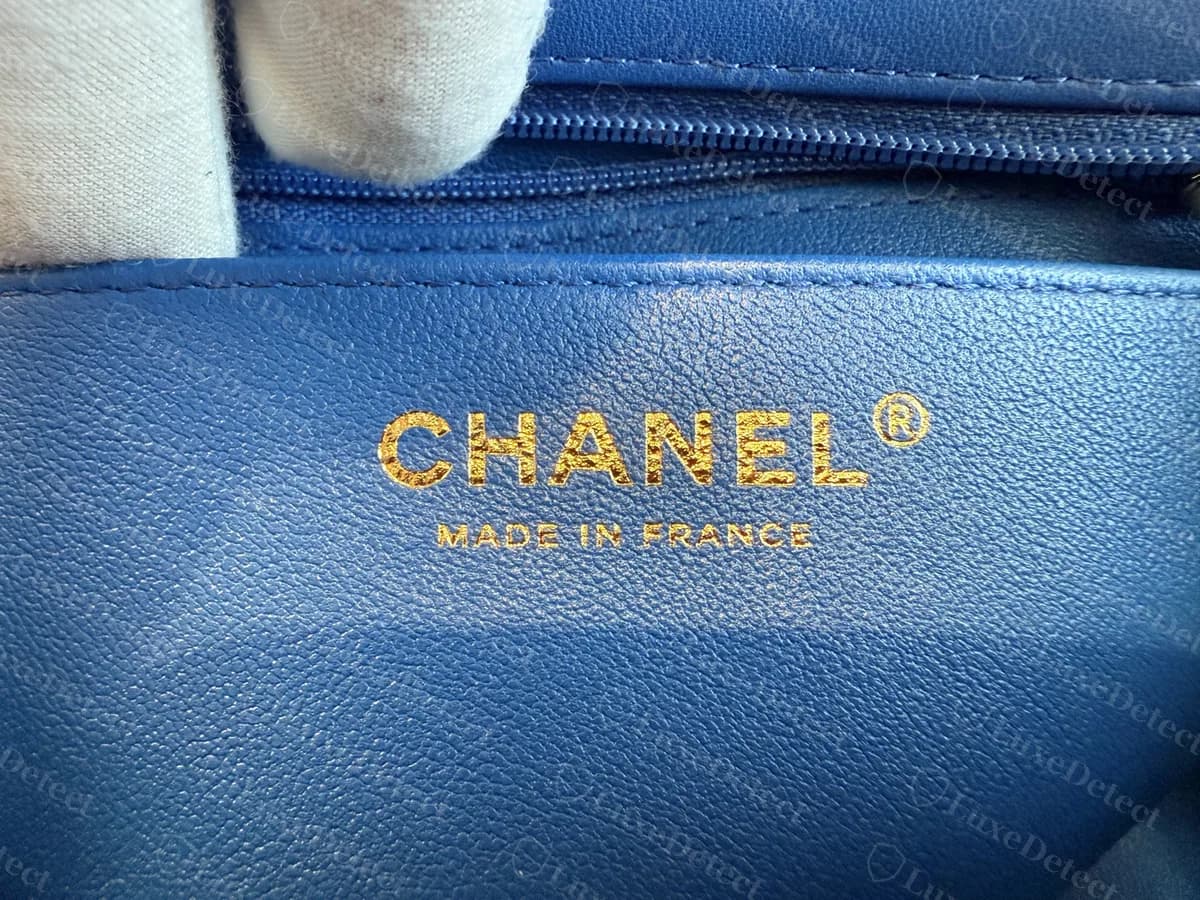 Genuine Mini Flap interior stamp on a blue leather lining, CHANEL with a registered mark above MADE IN FRANCE