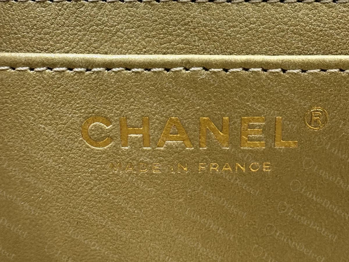 Genuine Mini Flap interior stamp in gold foil on a gold lining: CHANEL with a registered mark, and MADE IN FRANCE in smaller letters beneath