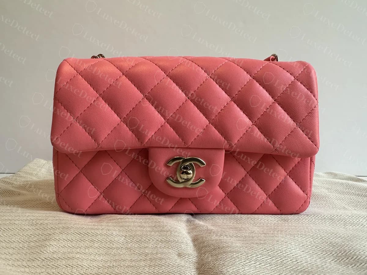 Genuine Chanel Mini Rectangular Flap in pink lambskin, front view: diamond quilting, a small rounded flap tab with the CC turnlock and a chain strap