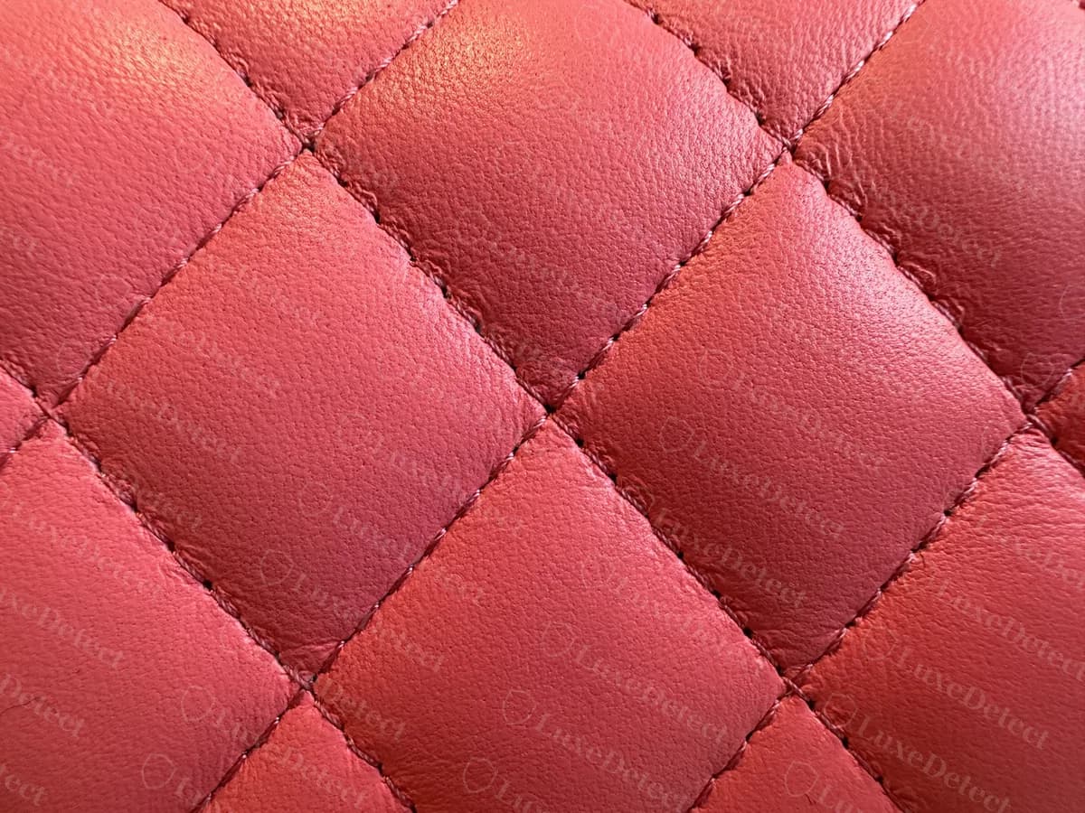 Close-up of genuine pink lambskin quilting on a Mini Flap: soft, slightly puffy diamonds with even stitching in matching thread