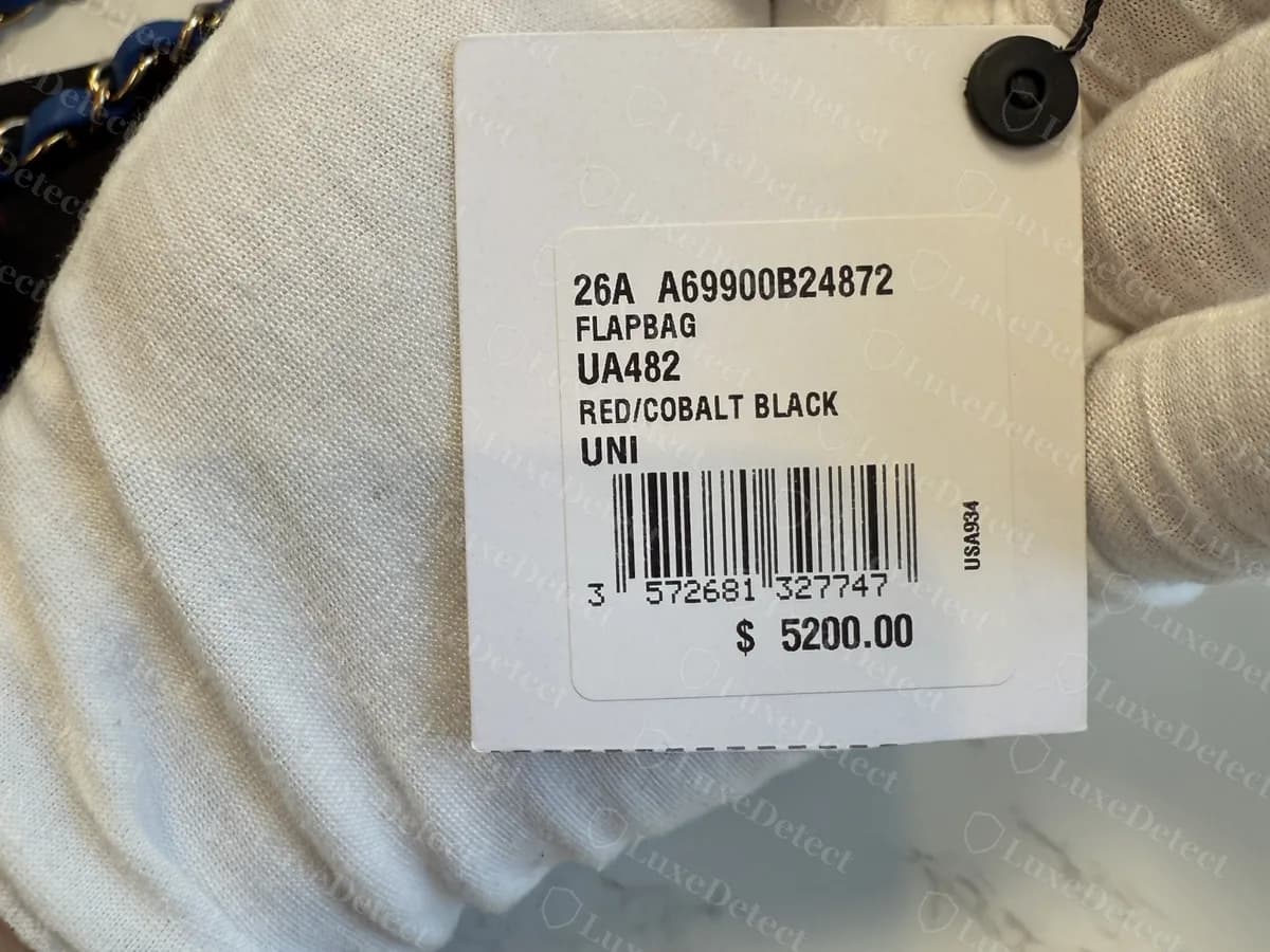 Genuine Chanel hang tag on a Mini Flap in tweed, showing season 26A, reference A69900B24872, the word FLAPBAG, a colour line, a barcode and a price