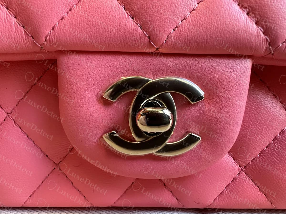 Genuine Mini Flap CC turnlock in light gold-tone metal on a pink lambskin flap tab, centred in the quilting