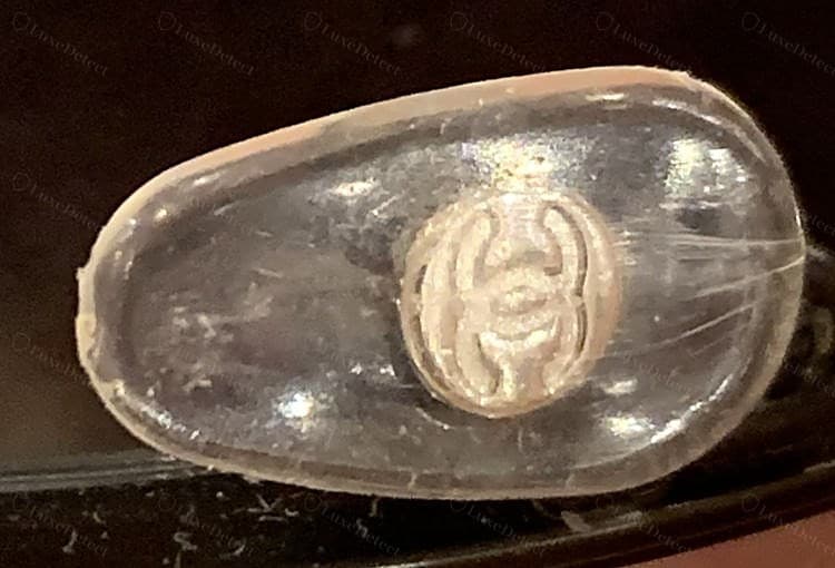 Genuine Chanel nose pad — the CC logo moulded cleanly into the silicone pad, both C's legible and correctly interlocked
